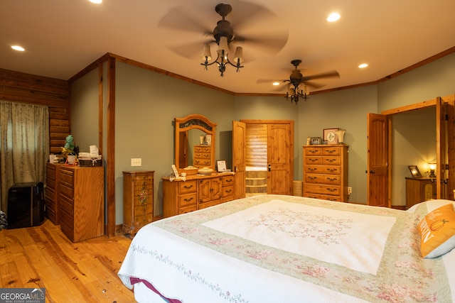 bedroom featuring ceiling fan, light hardwood / wood-style floors, ornamental molding, and wooden walls