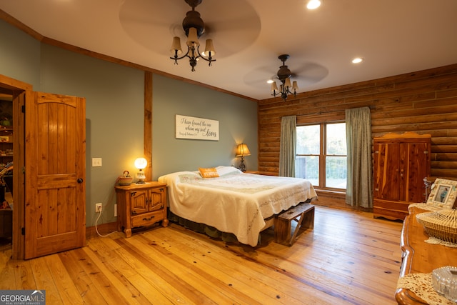 bedroom with rustic walls, ceiling fan, light hardwood / wood-style floors, and ornamental molding