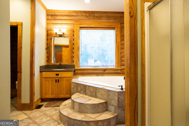 bathroom with shower with separate bathtub, vanity, and tile patterned floors