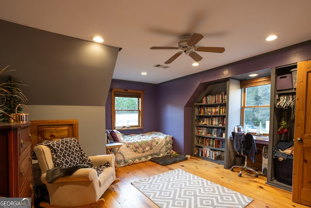 bedroom with hardwood / wood-style floors and ceiling fan