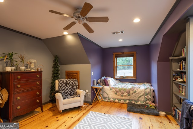 bedroom with ceiling fan, light hardwood / wood-style flooring, vaulted ceiling, and ornamental molding