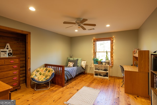 bedroom with ceiling fan and light hardwood / wood-style flooring