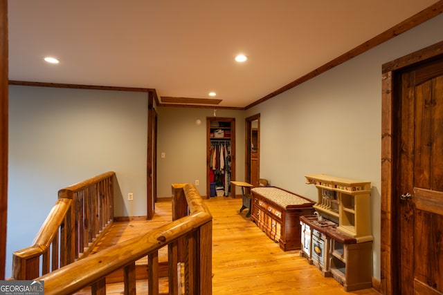 hall featuring light wood-type flooring and crown molding