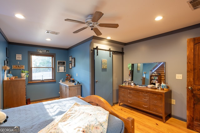 bedroom with light hardwood / wood-style floors, ceiling fan, and ornamental molding