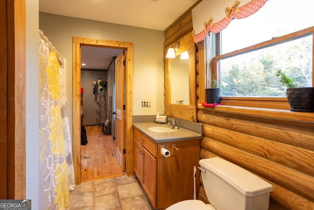 bathroom with toilet, vanity, and hardwood / wood-style flooring