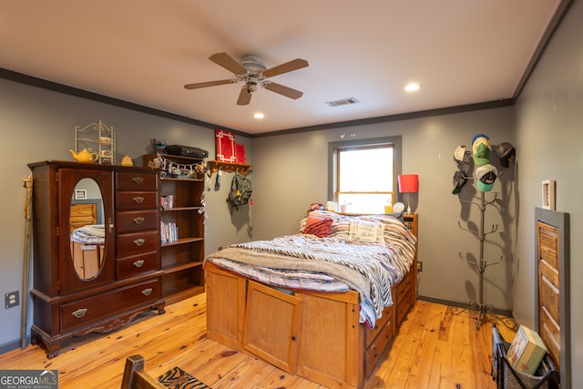 bedroom featuring ceiling fan, light wood-type flooring, and crown molding