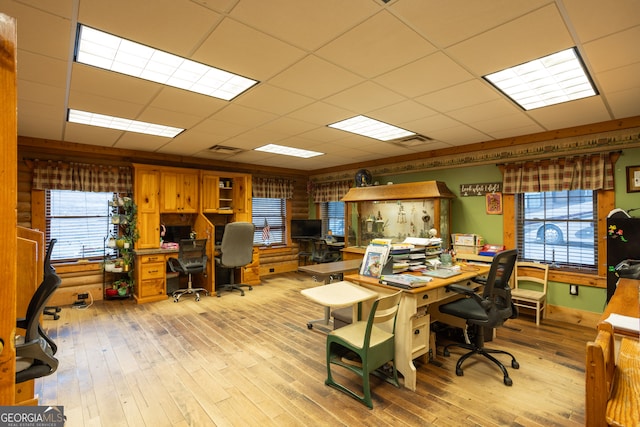 office area featuring a paneled ceiling and light hardwood / wood-style flooring