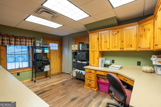 office area featuring a paneled ceiling and dark hardwood / wood-style floors