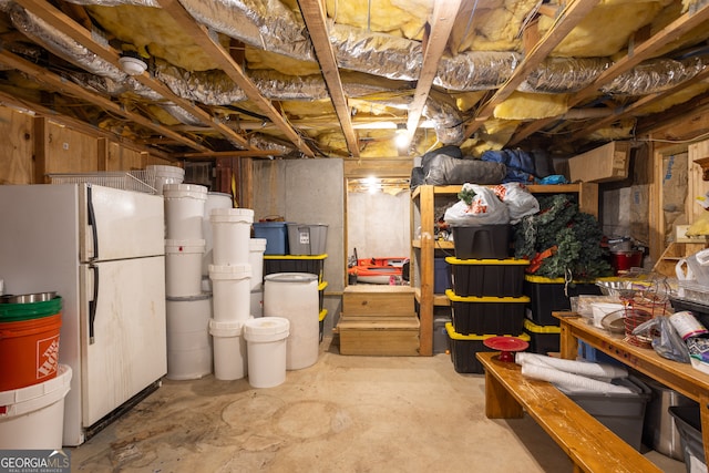 basement with white refrigerator