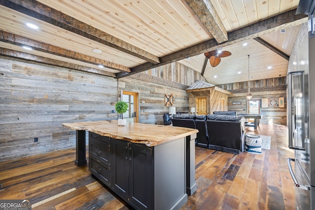 kitchen with wood walls, dark hardwood / wood-style floors, and a center island