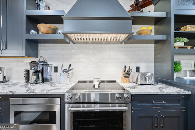 kitchen with tasteful backsplash, light stone counters, custom range hood, and appliances with stainless steel finishes