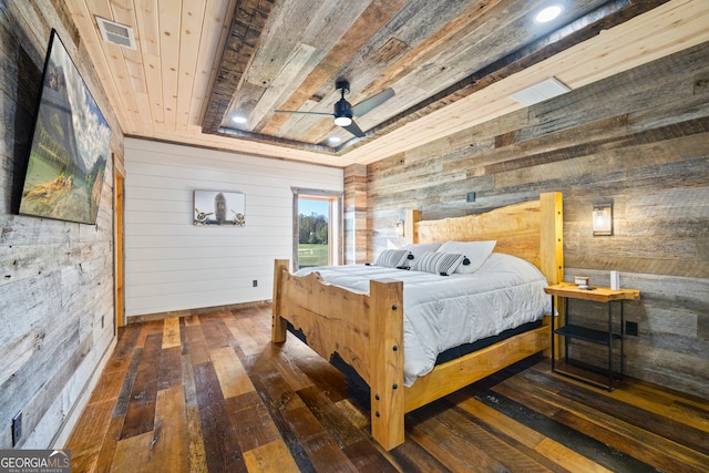 bedroom featuring wood ceiling, wood walls, ceiling fan, and dark wood-type flooring