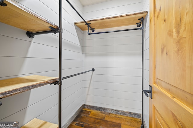 bathroom featuring wooden walls