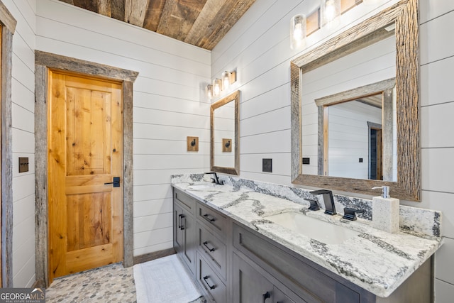 bathroom featuring vanity, wooden ceiling, and wood walls