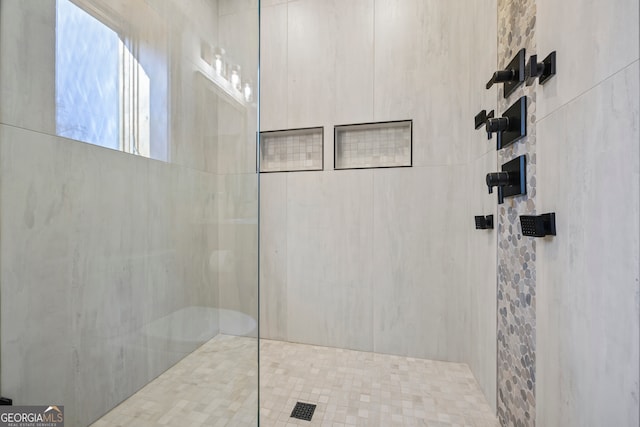 bathroom with tiled shower