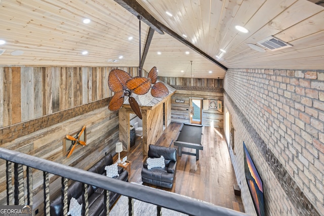 interior space featuring wood-type flooring, lofted ceiling with beams, wooden ceiling, and wood walls