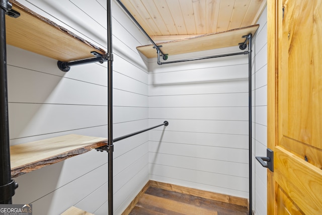 bathroom with wood-type flooring, wood ceiling, and wooden walls