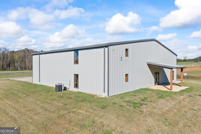 view of property exterior with a yard and an outdoor structure