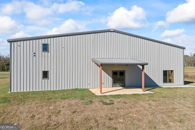 view of outbuilding with a lawn