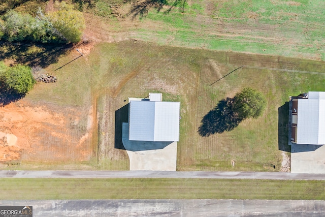 birds eye view of property with a rural view