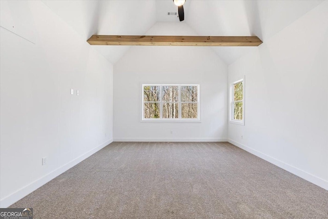 carpeted empty room with visible vents, baseboards, and beam ceiling