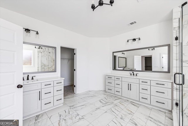 full bathroom with marble finish floor, visible vents, a sink, and a spacious closet