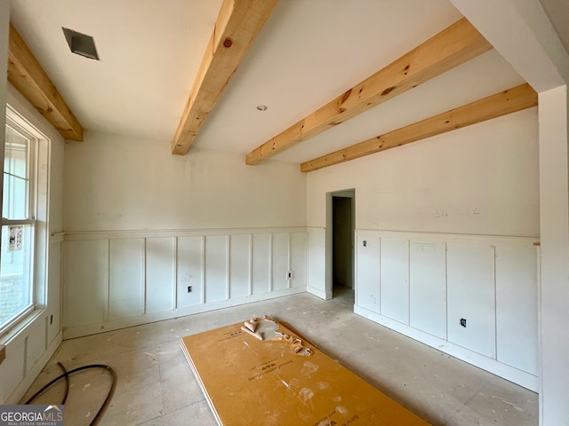 additional living space with beamed ceiling and a wealth of natural light