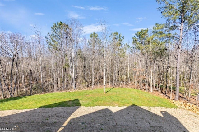 view of yard featuring a view of trees