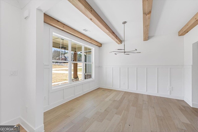 unfurnished dining area featuring beam ceiling, visible vents, and light wood finished floors