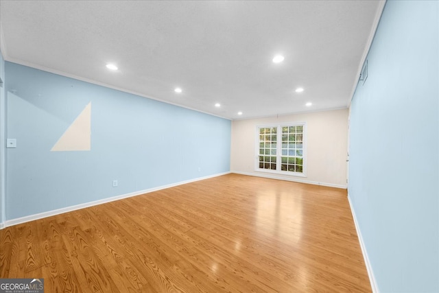 unfurnished room with light hardwood / wood-style floors and ornamental molding