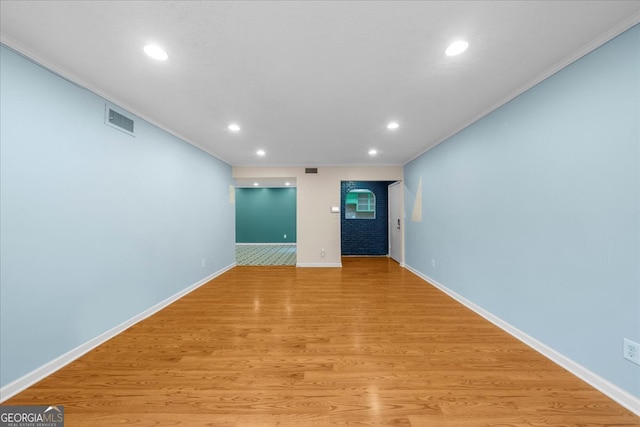 unfurnished living room with light hardwood / wood-style flooring and ornamental molding