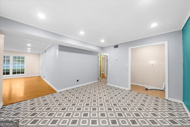 basement featuring crown molding and light wood-type flooring