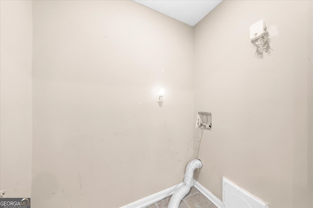 washroom featuring hookup for an electric dryer and light tile patterned floors