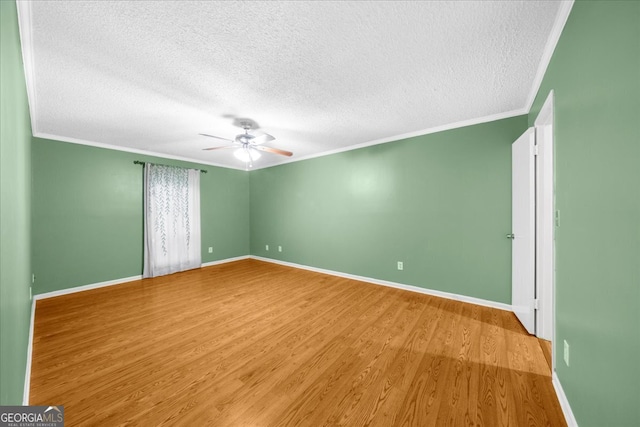 spare room featuring ceiling fan, ornamental molding, a textured ceiling, and light hardwood / wood-style flooring