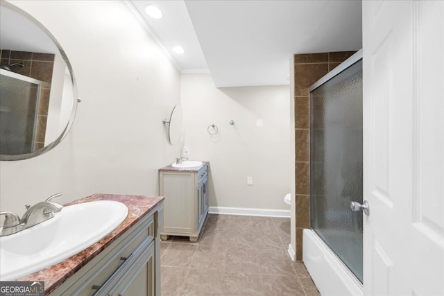 full bathroom with enclosed tub / shower combo, tile patterned floors, toilet, vanity, and ornamental molding