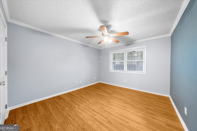 unfurnished room featuring a textured ceiling, light hardwood / wood-style flooring, and ornamental molding