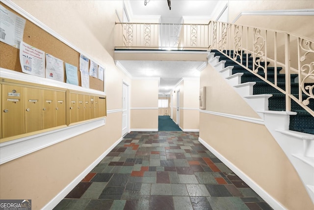 corridor featuring mail boxes and ornamental molding