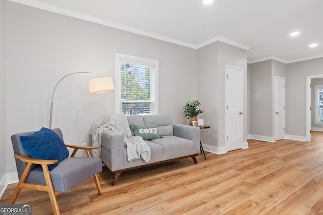 sitting room featuring light hardwood / wood-style flooring and crown molding