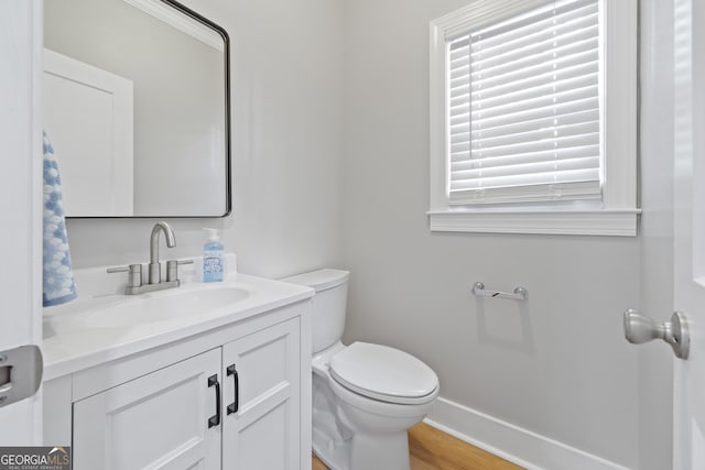 bathroom featuring hardwood / wood-style floors, vanity, and toilet