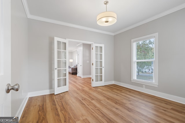 unfurnished room featuring crown molding, french doors, and light hardwood / wood-style flooring