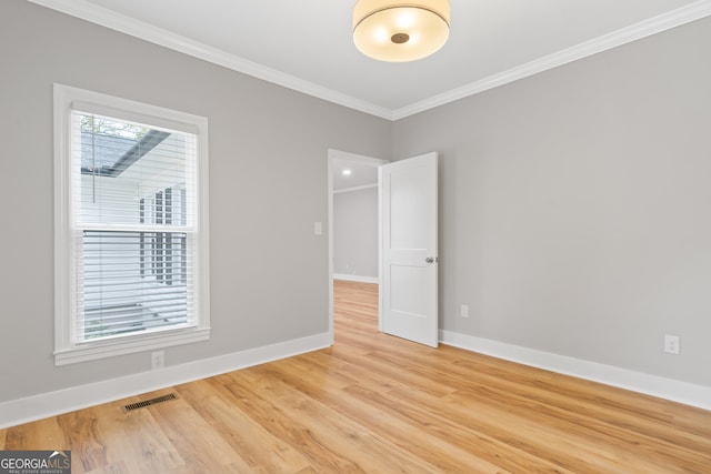 unfurnished room featuring crown molding and hardwood / wood-style floors