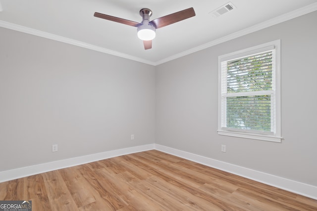 empty room featuring ceiling fan, a healthy amount of sunlight, ornamental molding, and light hardwood / wood-style flooring