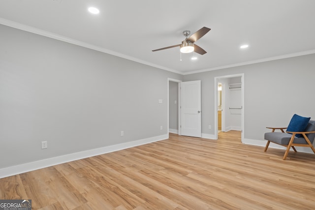 interior space with light hardwood / wood-style floors, ceiling fan, and ornamental molding