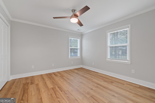 unfurnished room featuring ceiling fan, ornamental molding, and light wood-type flooring