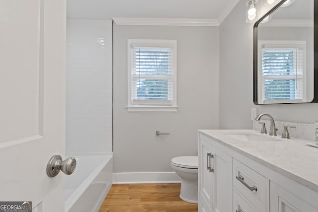 full bathroom featuring shower / bathing tub combination, vanity, hardwood / wood-style flooring, toilet, and ornamental molding