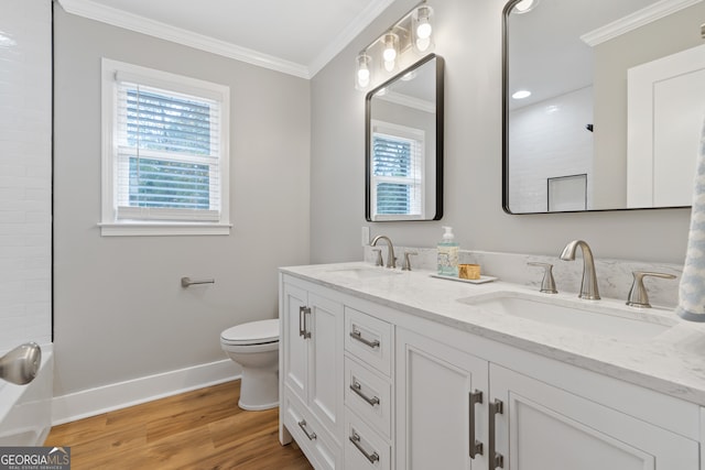 bathroom featuring wood-type flooring, vanity, toilet, and crown molding