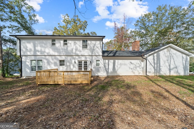 rear view of property featuring a lawn and a wooden deck