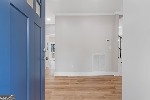 interior space with crown molding and wood-type flooring