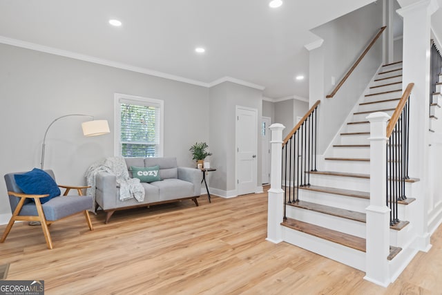 interior space featuring light wood-type flooring and ornamental molding