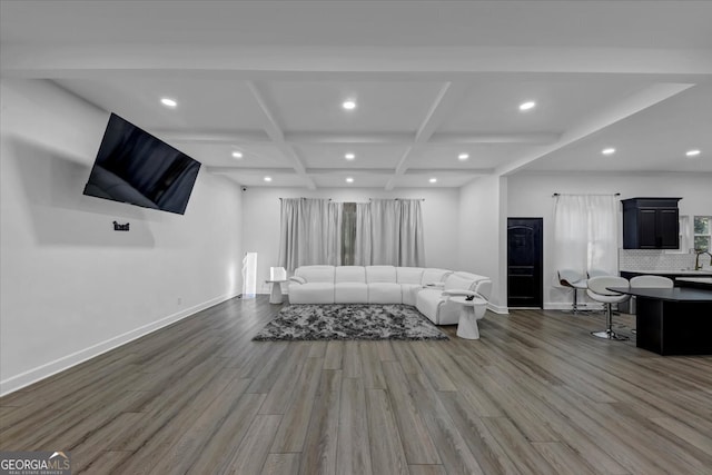 living room with hardwood / wood-style floors, beamed ceiling, and coffered ceiling